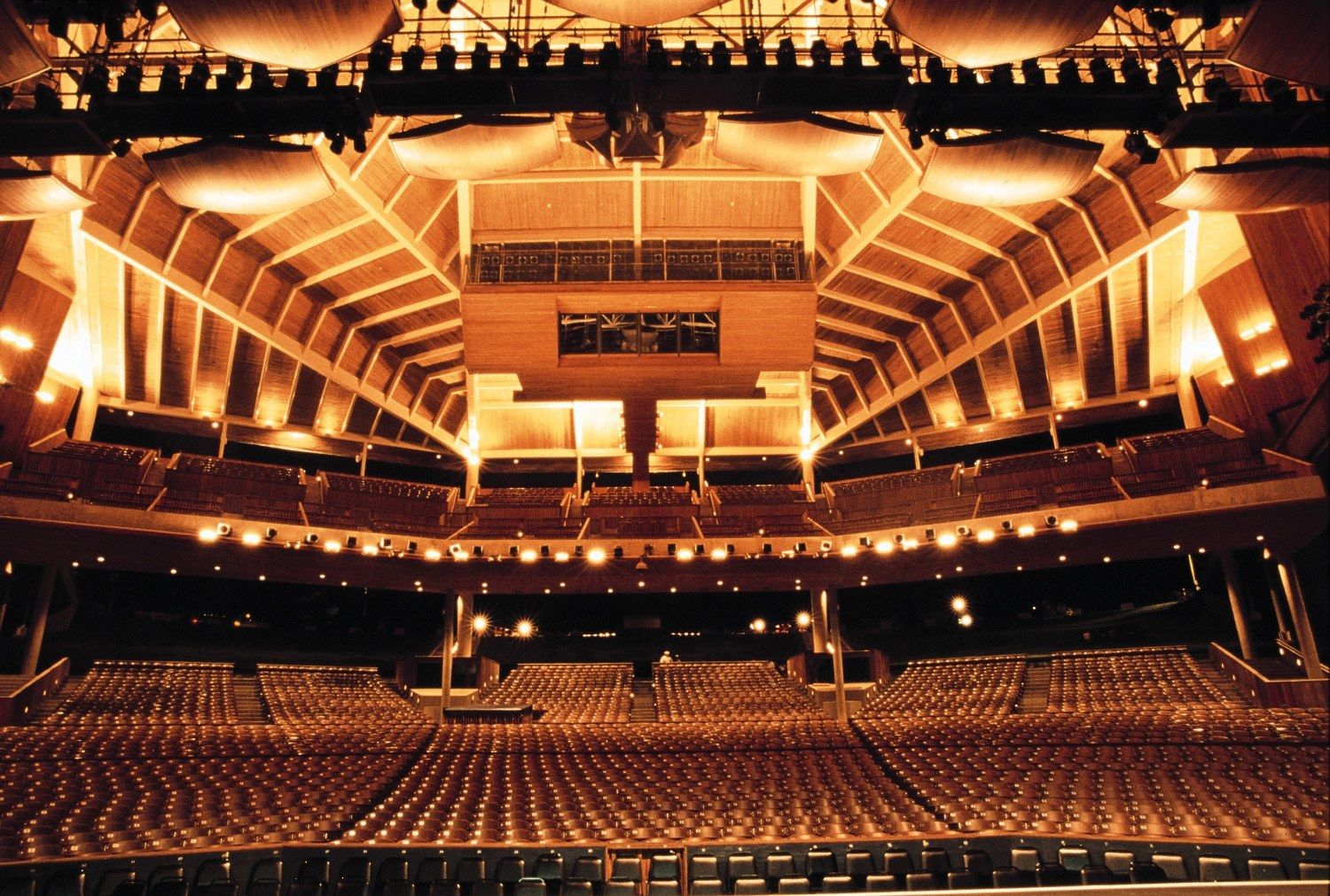 Interior of the Filene Center at Wolf Trap, a large wooden open-sided amphitheater, seen from the stage
