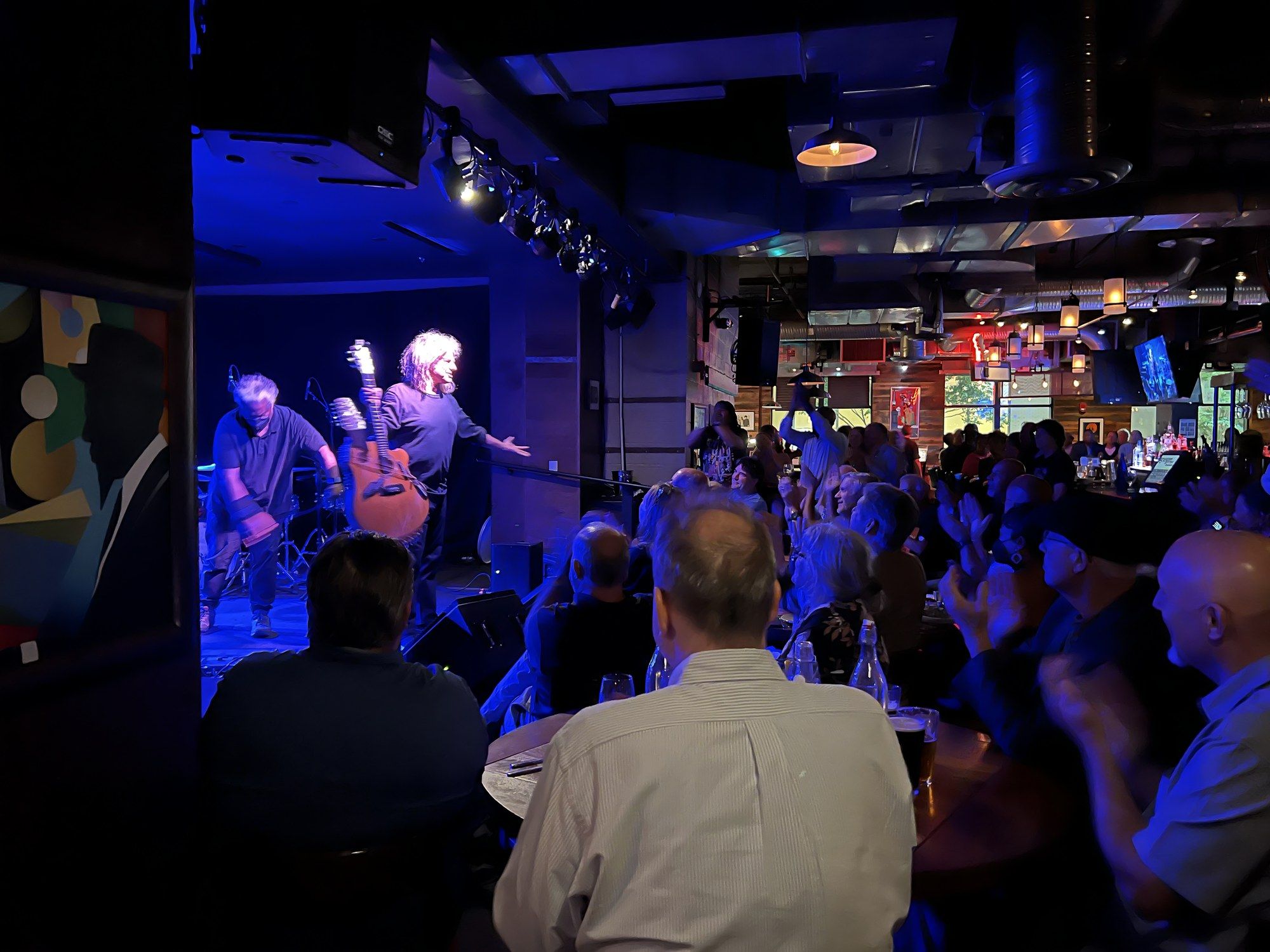 Pat Metheny and bassist Linda May Han Oh taking a bow on stage
