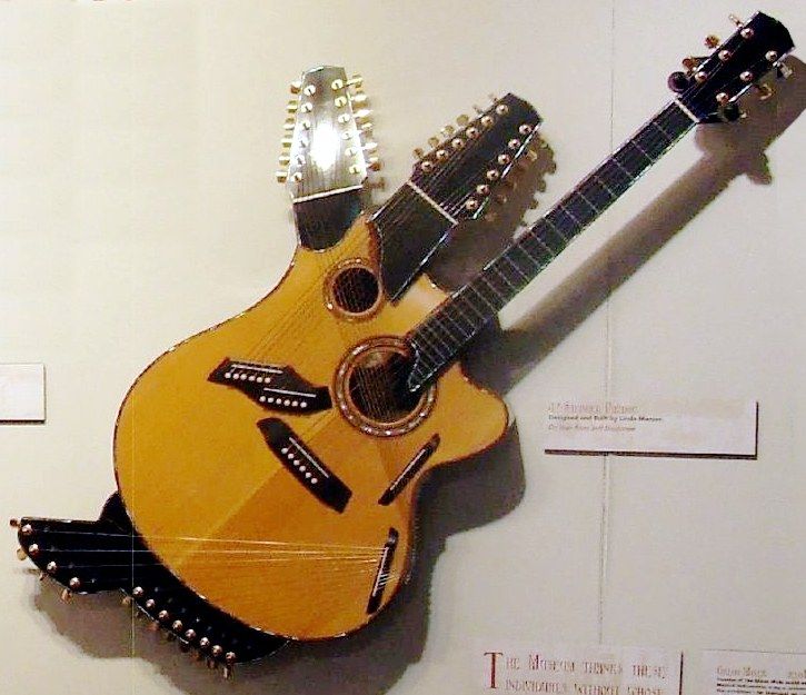 A Linda Manzer 42-string Pikasso guitar on display on a museum wall