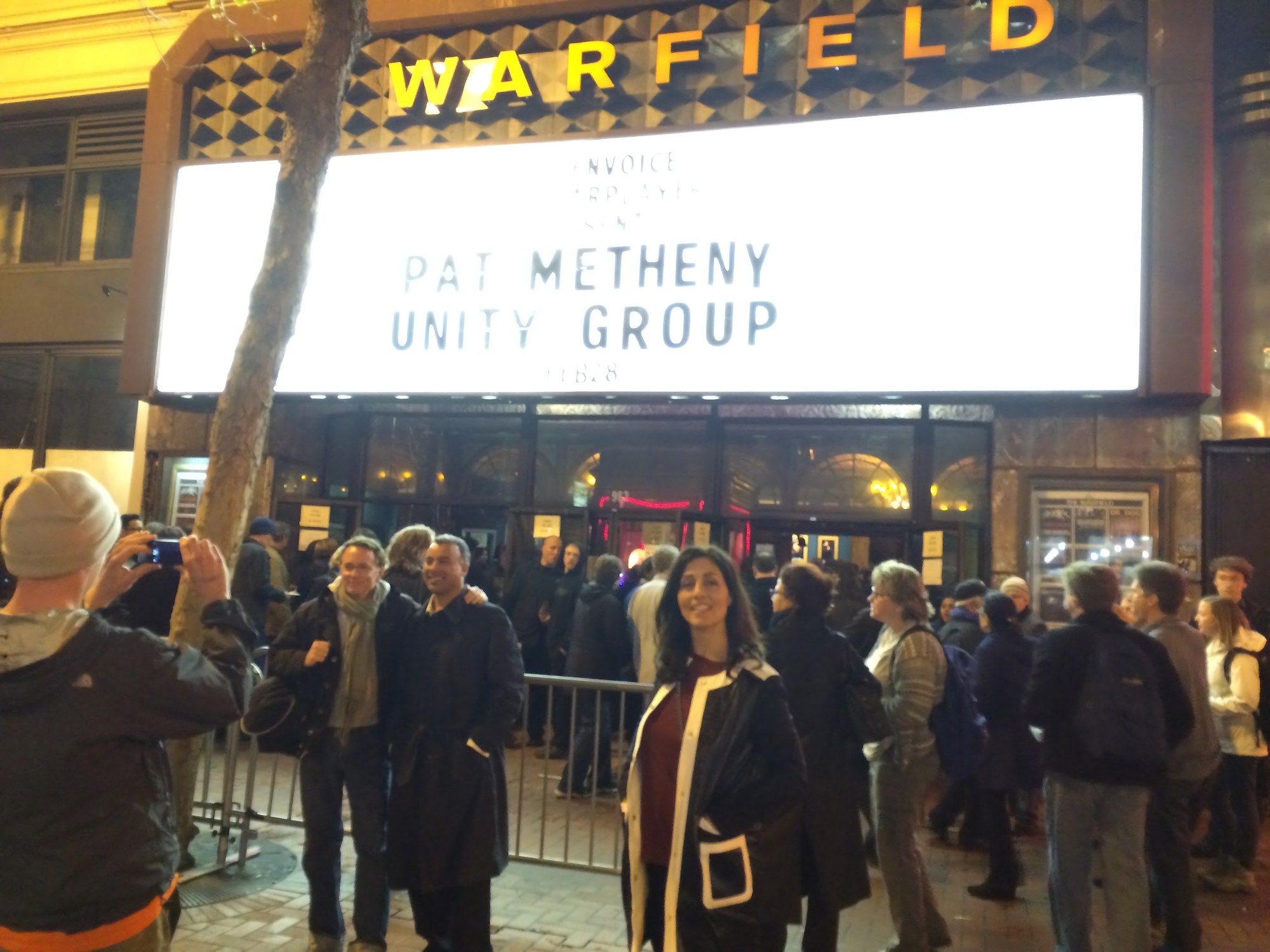 The Warfield marquee lit up at night reading “Pat Metheny Unity Group,” with people gathered on the sidewalk below
